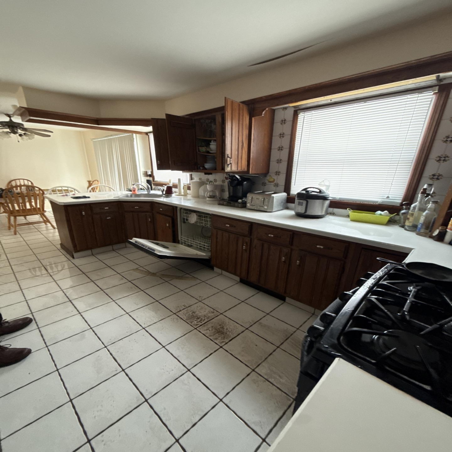Kitchen tile floor affected by a dishwasher leak during cleanup in New Jersey
