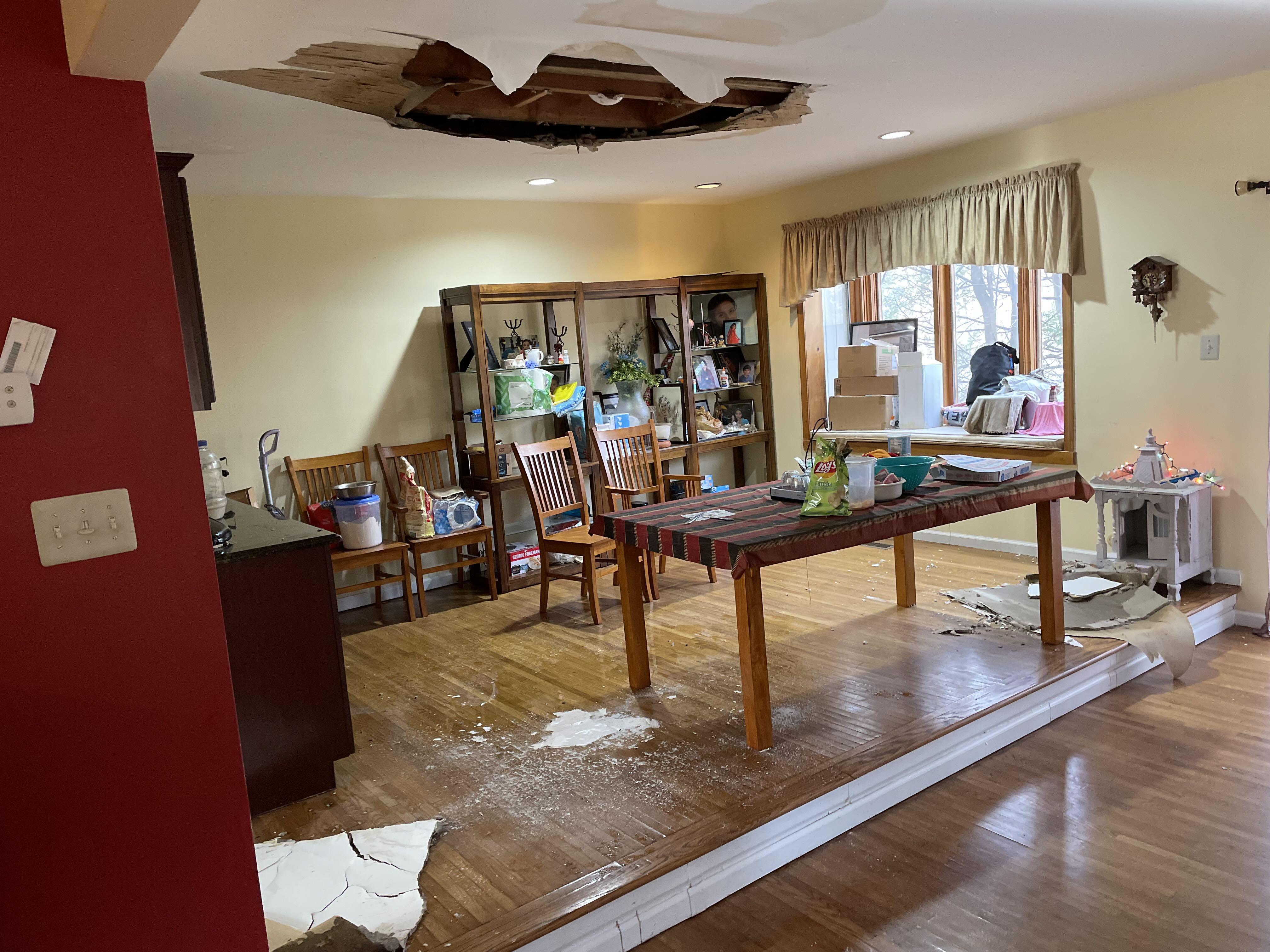 Living room ceiling damaged from overflowed toilet