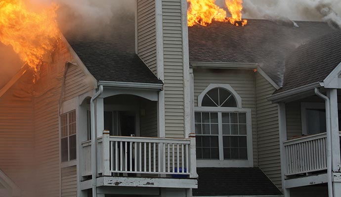 residential white siding home roof fire damage